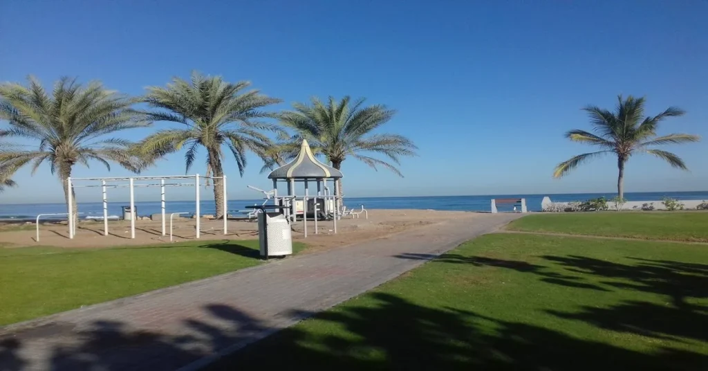 Azaiba Beach Muscat, a beautiful picture with beach side green grass and palm trees