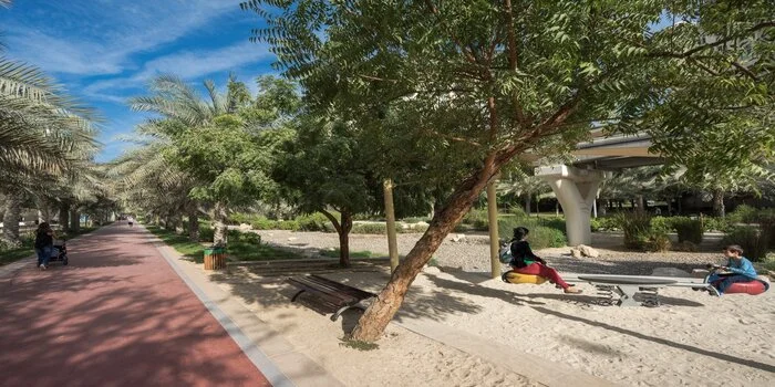 Al Ittihad Park Palm Jumeirah Dubai showing jogging tracks, playgrounds, and green landscaped areas