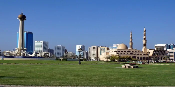 Al Mahatta Park in Sharjah with green lawns walking paths and kids play area