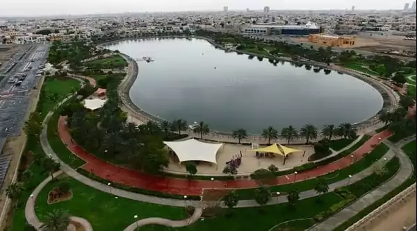 Al Qusais Pond Park Dubai with jogging track, pond and green walking area