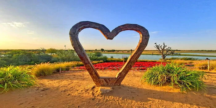 Love Lake Dubai heart-shaped lake in Al Qudra desert with scenic sunset and desert landscape