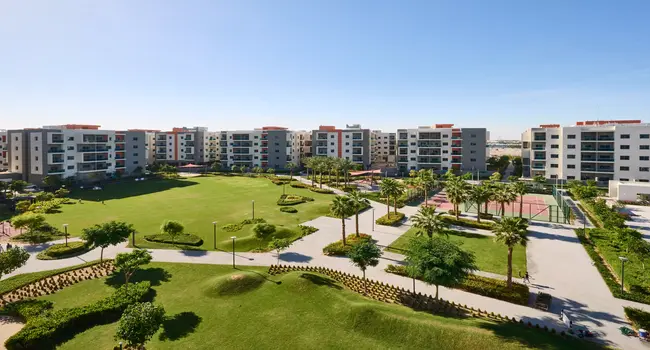 Wasl Green Park Dubai showing walking tracks, green lawns, and community park area